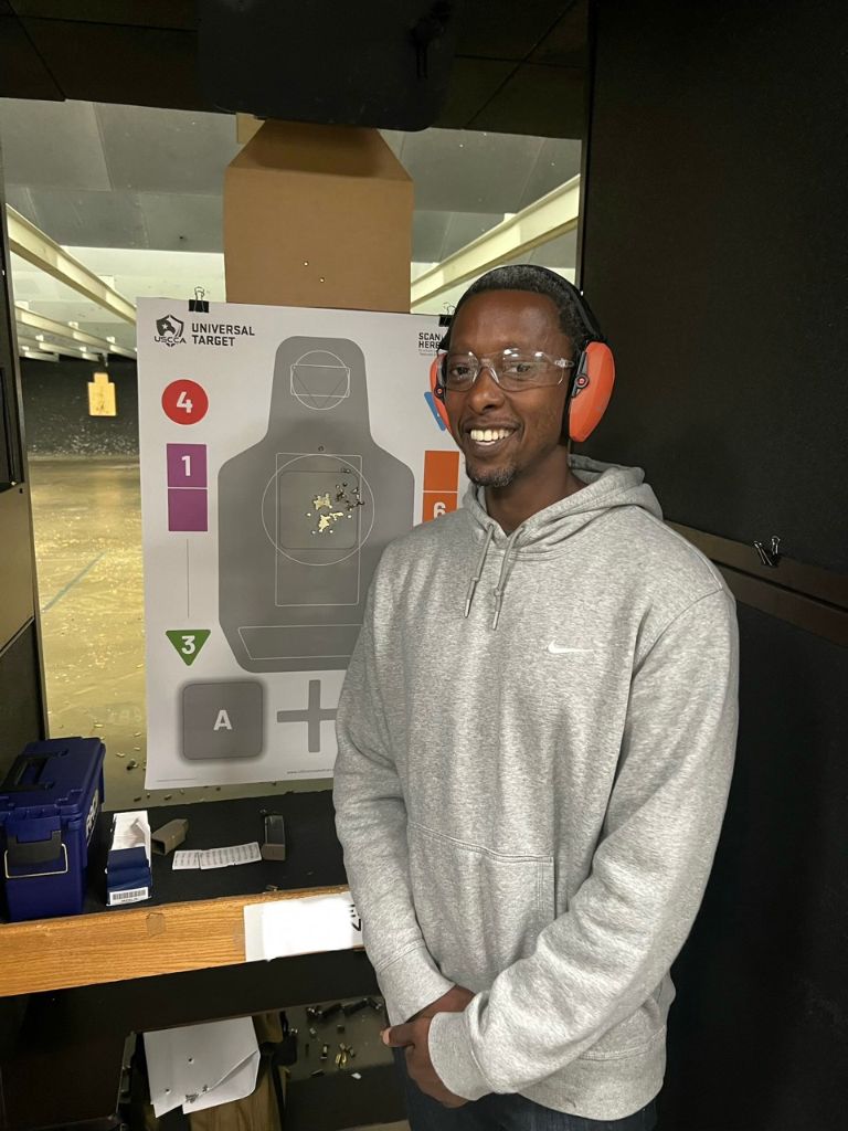 Student standing beside a range target during training